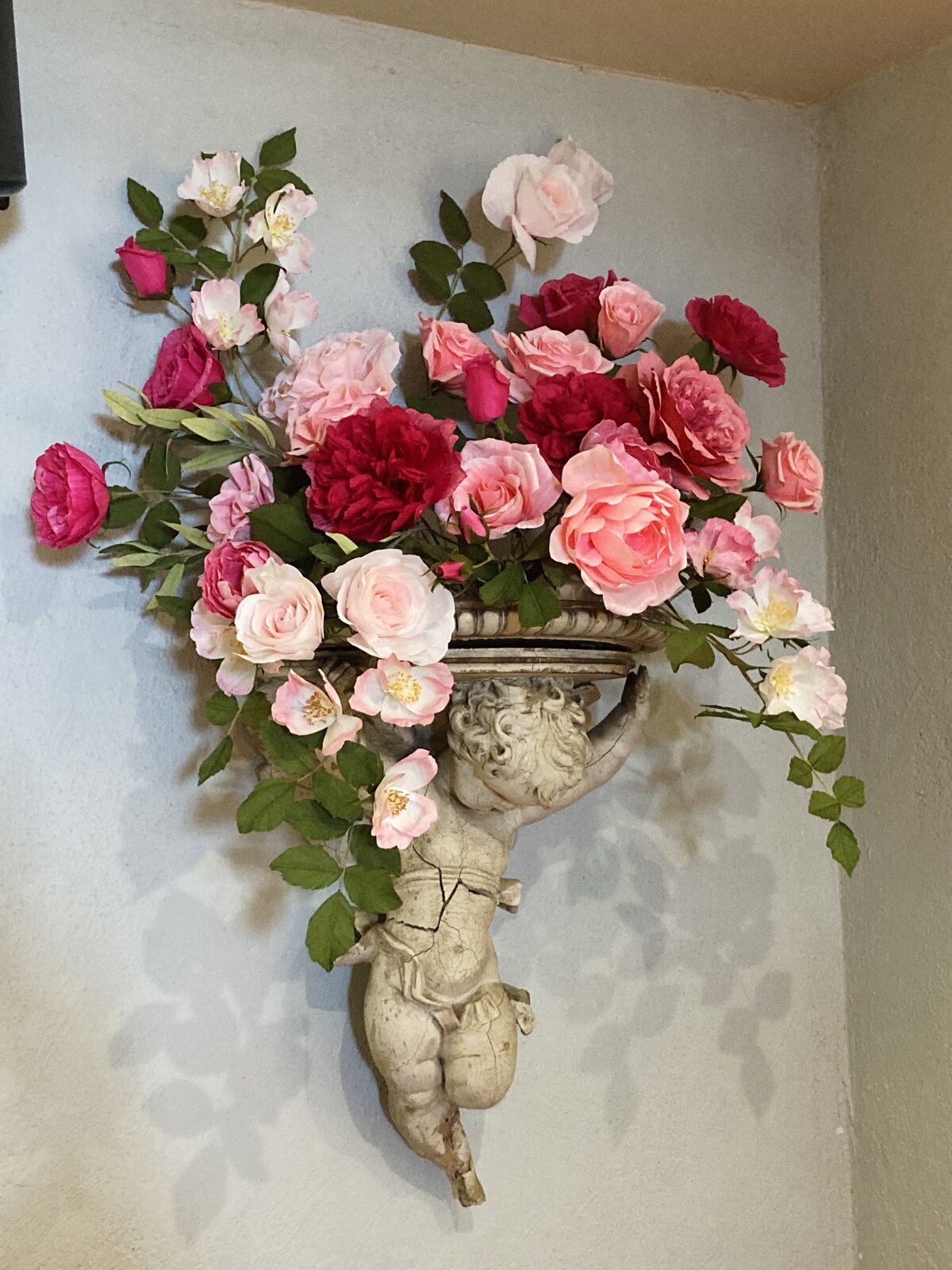 Pedestal adorned with paper roses