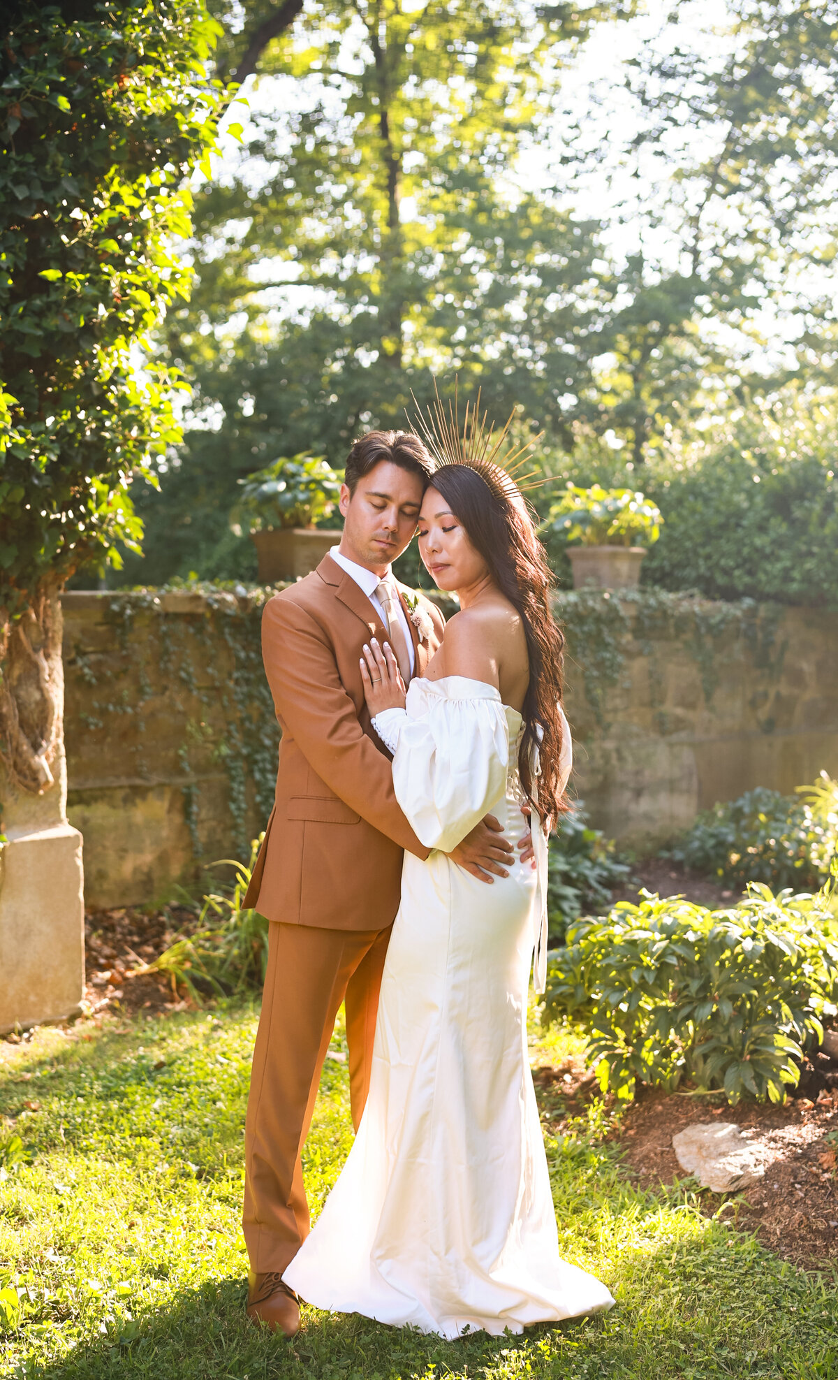 bride and groom holding each other wearing vintage wedding dress and brown suit in miami gardens florida