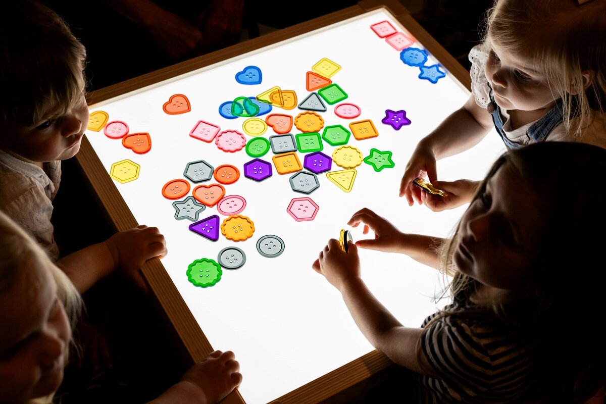Students playing and learning using the light up board at The Nest, a preschool and learning center in Surf City, North Carolina