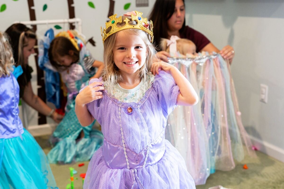 A young student wearing a purple princess dress at The Nest, a preschool and learning center in Surf City, North Carolina