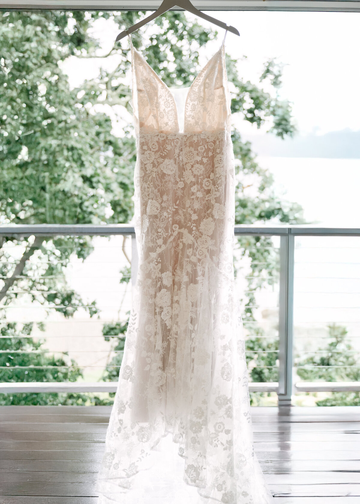 wedding dress hangin in doorway overlooking puget sound