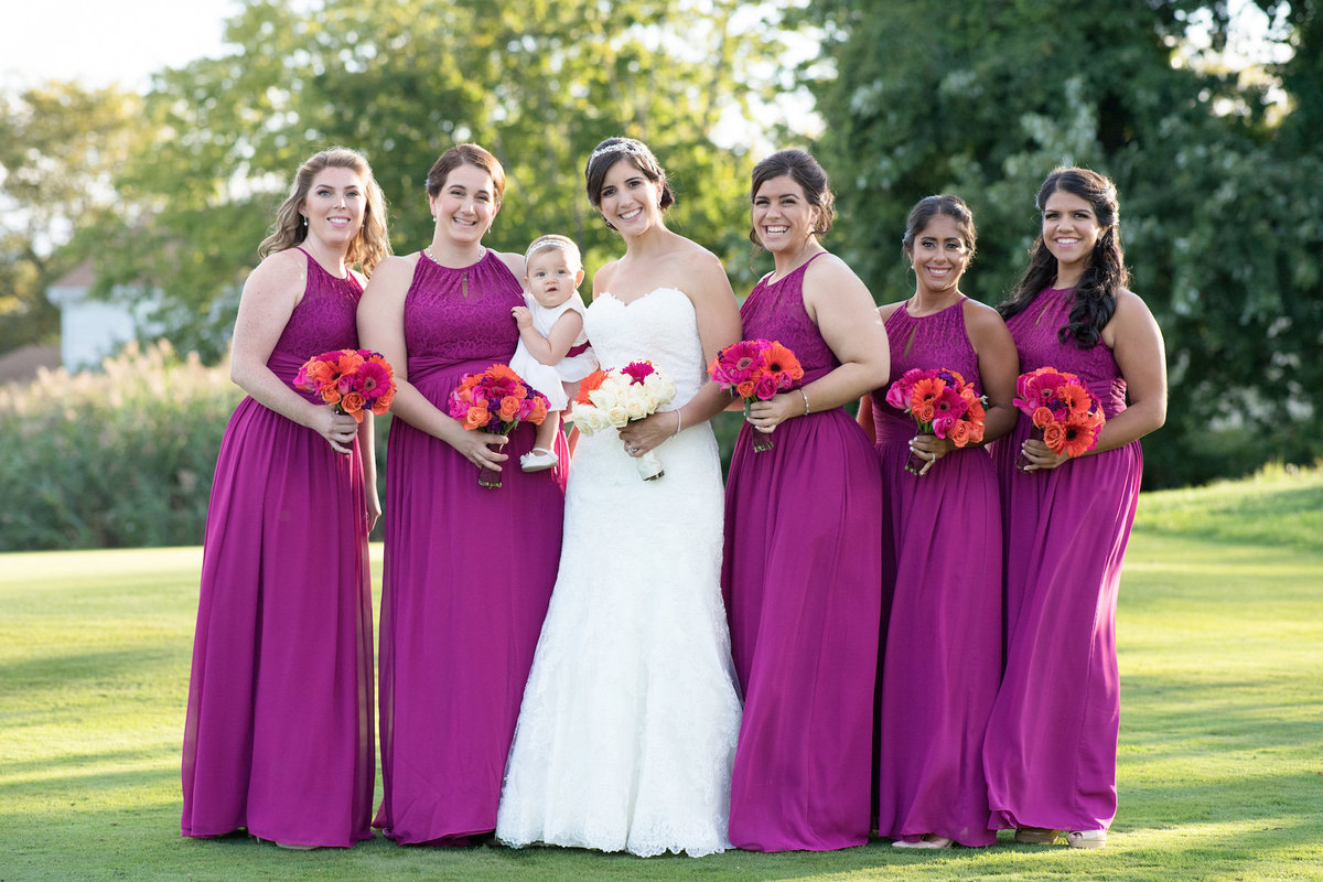 photo of bride with bridesmaids outside wedding reception at Lawrence Yacht and Country Club
