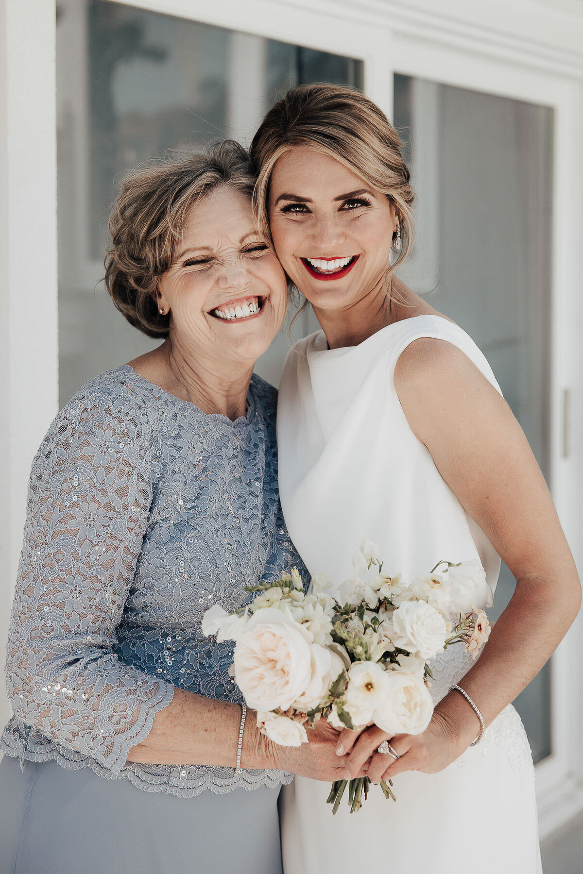 Bride and Mother of the Bride happily smiling together