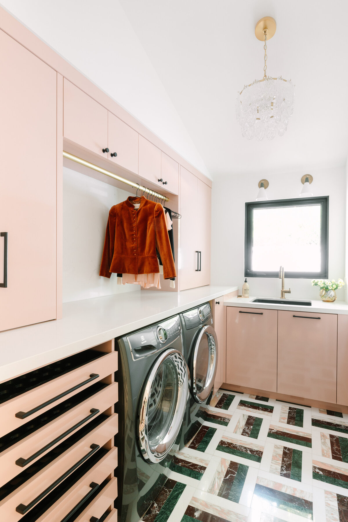 Modern Hollywood regency laundry room with pink high gloss cabinets, Caesarstone Quartz counters, and Arc Passion 12x12 Polished Marble By Elizabeth Sutton: Pattern 12 flooring with pink, green and burgundy marble.
