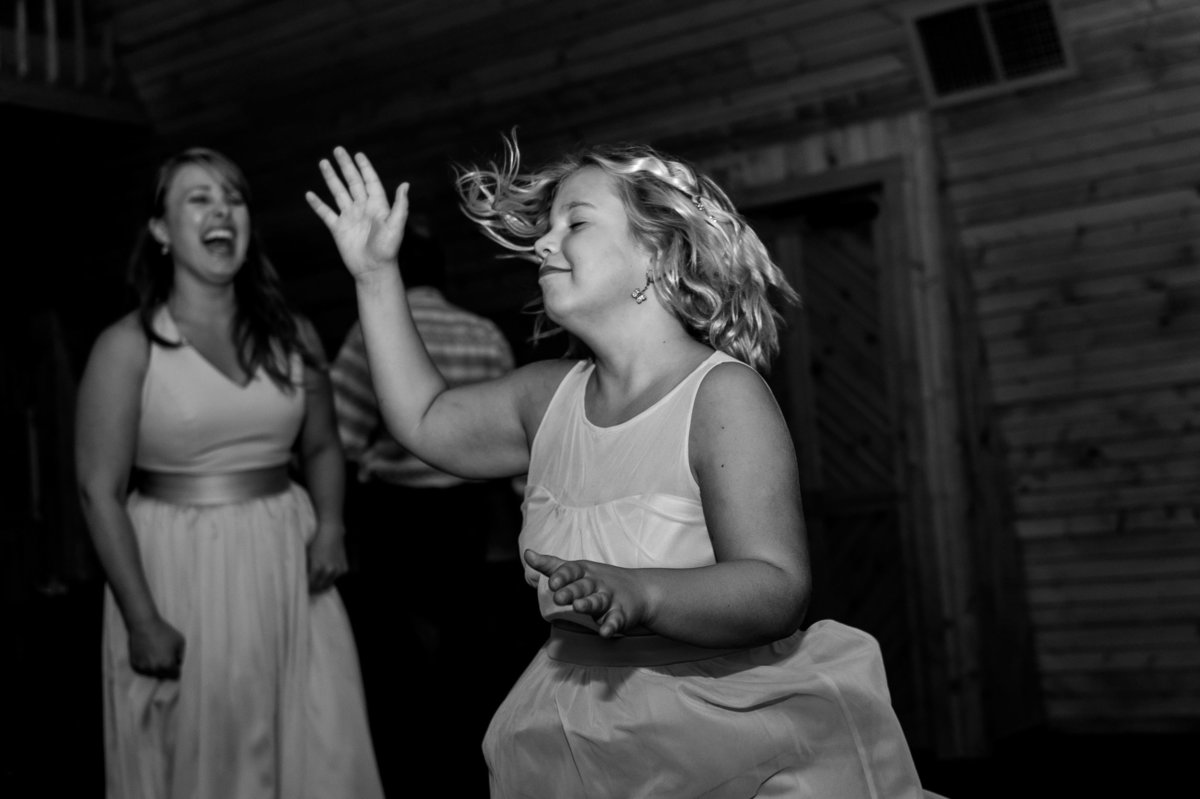 young girl dances freely at reception