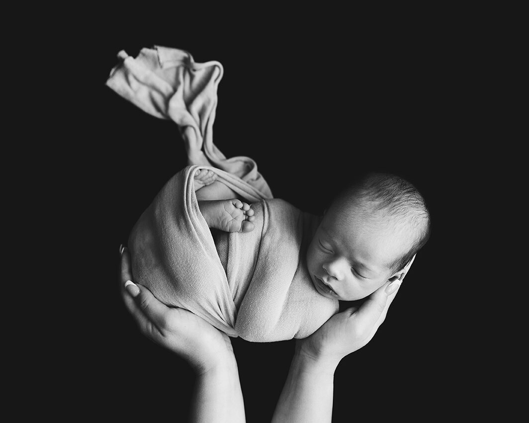 black and white baby in hands