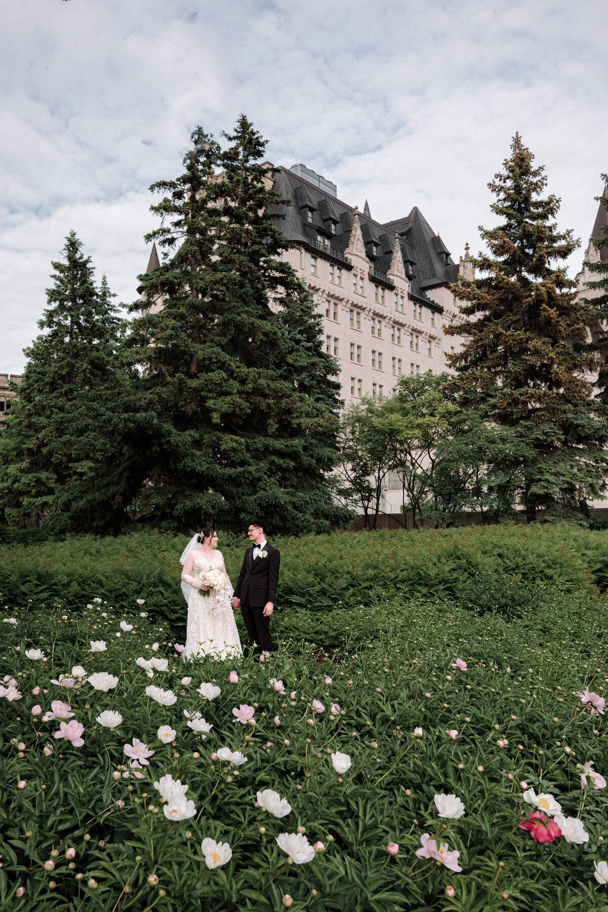 bride and groom taking in their surroundings outside the fairmont as spring flowers bloom for them