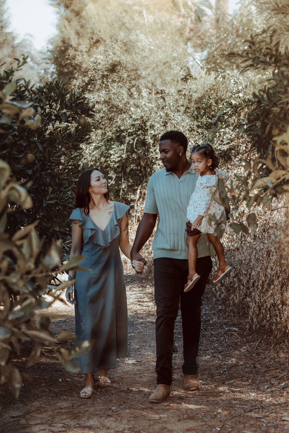 Family Walking Through Trees – Prospect Park Redlands Family Photos