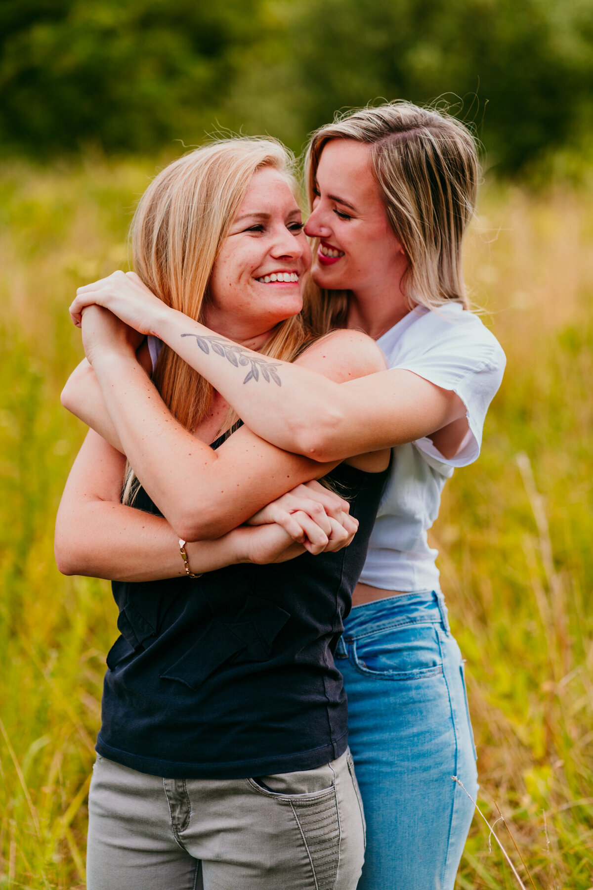  Couple hugging tightly in a golden field with joyful smiles
