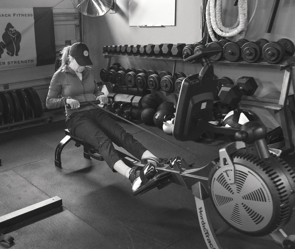 Woman is doing rows at Silverback Fitness. She is in a personal training session with Sarnia's best personal trainer Jim Stewart with Silverback Fitness.