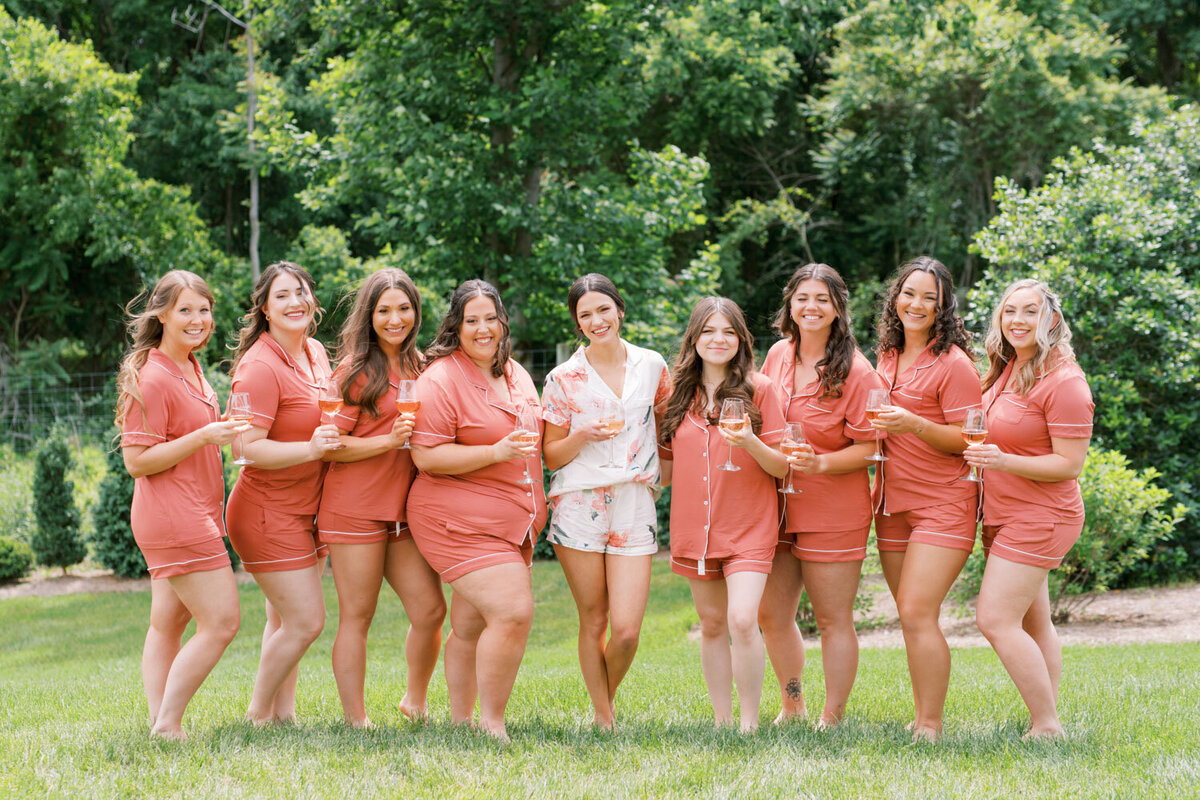 Bride and bridesmaids standing in the field