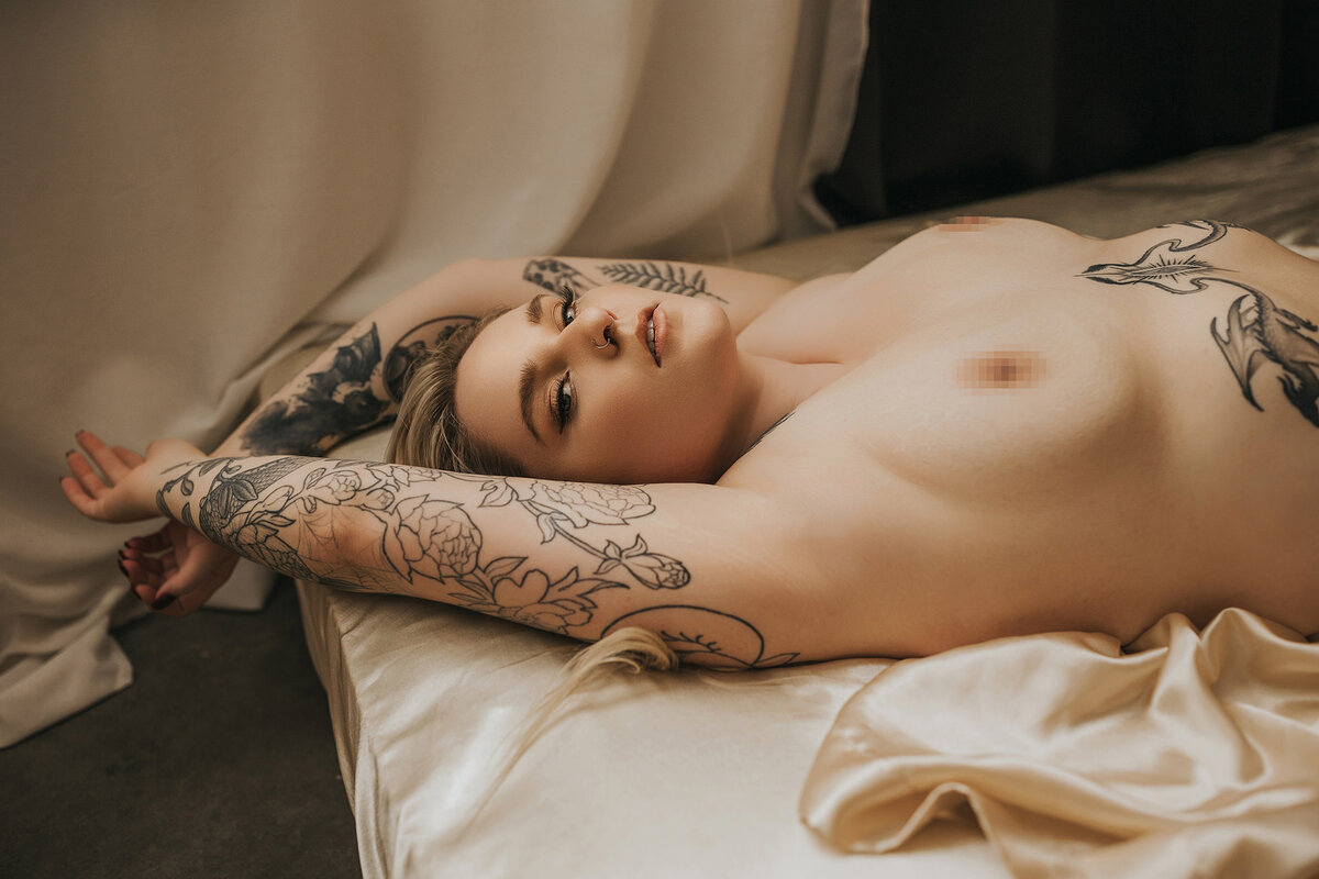 woman posing in front of moody decorated wall in vancouver boudoir studio