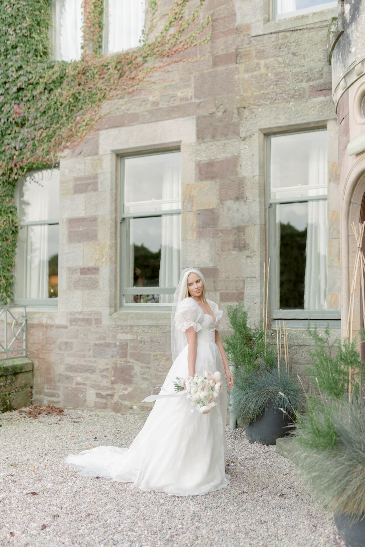 Bridal portrait featuring peony wedding bouquet and silk patterned wedding dress, in the grounds Cromlix House, Scotland, photographed by fine art wedding photographer UK.