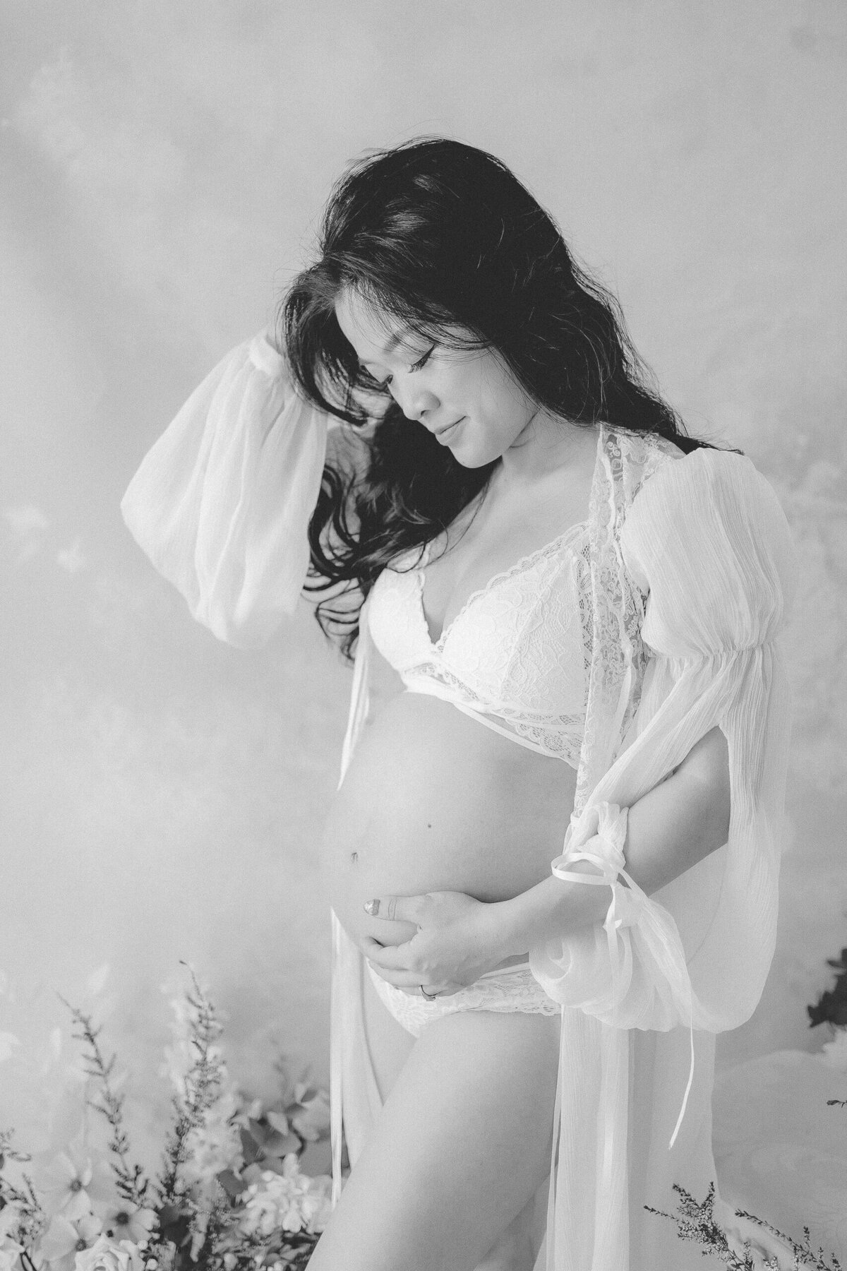 Radiate in the beauty of pregnancy moments with a mum in a maternity dress at Gold Coast's natural light studio.