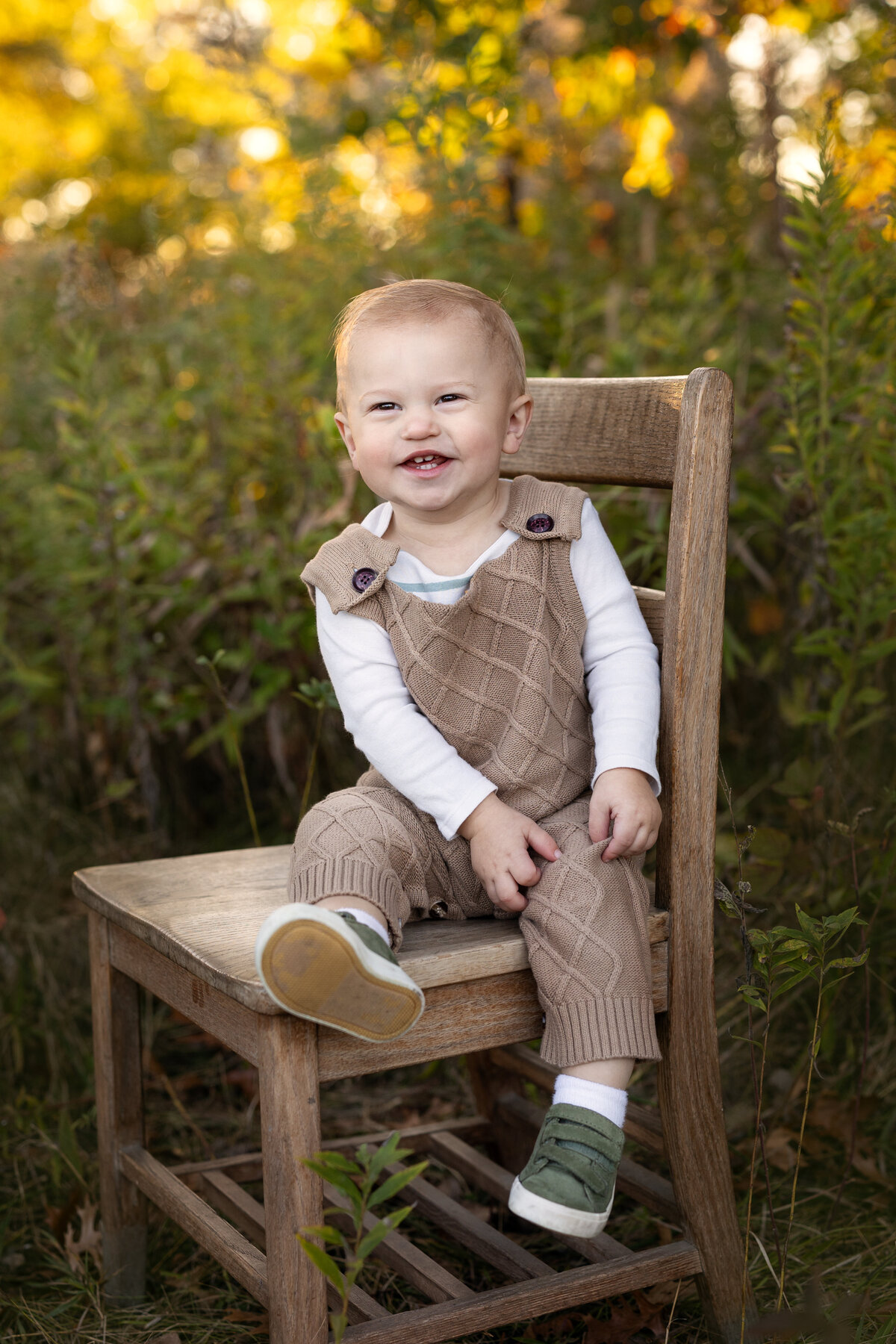 boy smiling in field in griffith indiana. photos done by brielle pausma photography