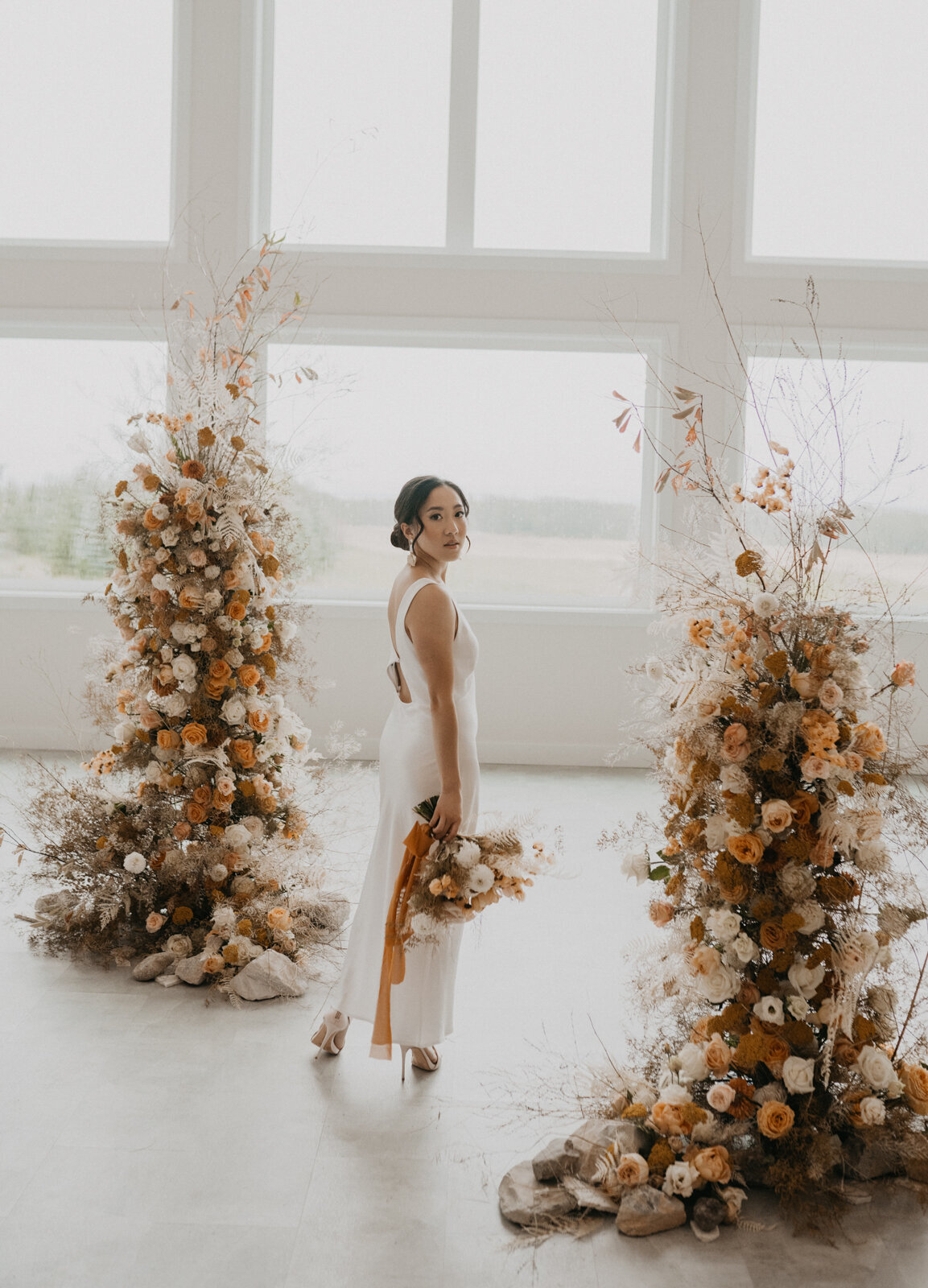 Elegant fall bridals at Tin Roof Event Centre, a modern wedding venue in Lacombe, Alberta, featured on the Brontë Bride Vendor Guide.