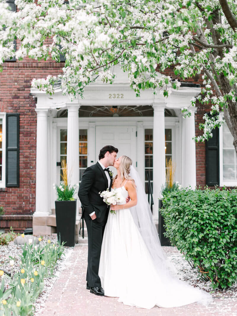 Bride and groom kissing by wedding planners in chicago