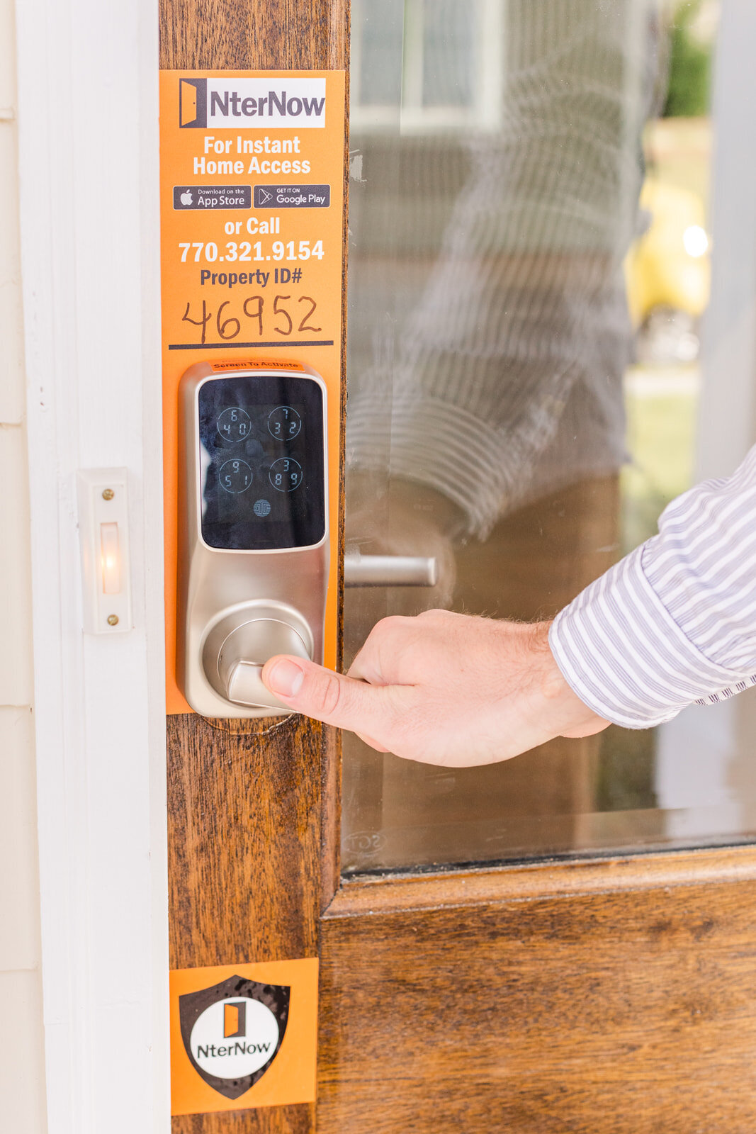 detail of a person opening a door using an app