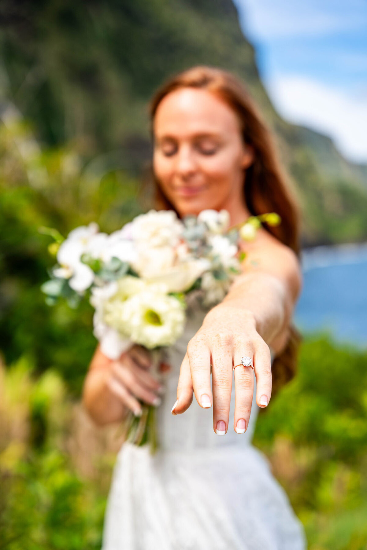 Bride holding flowers and showing off her ring on the Big Island