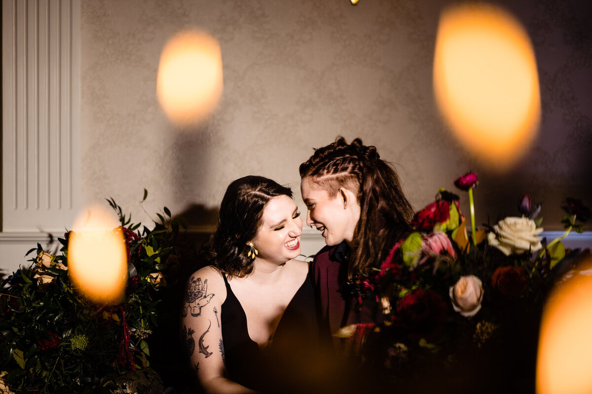 Brides smiling while leaning their foreheads together