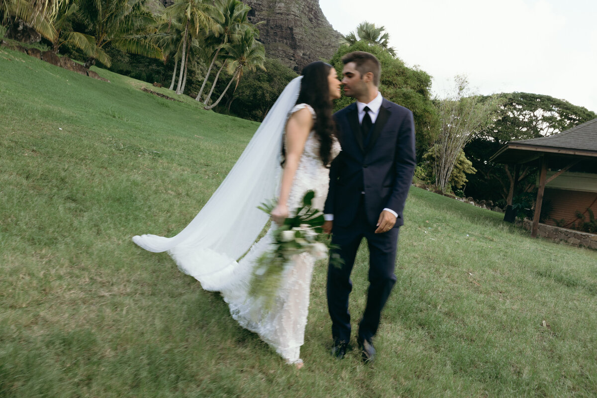 Luxury wedding couple at five-star Hawaiian resort, bride in strapless satin gown and long veil