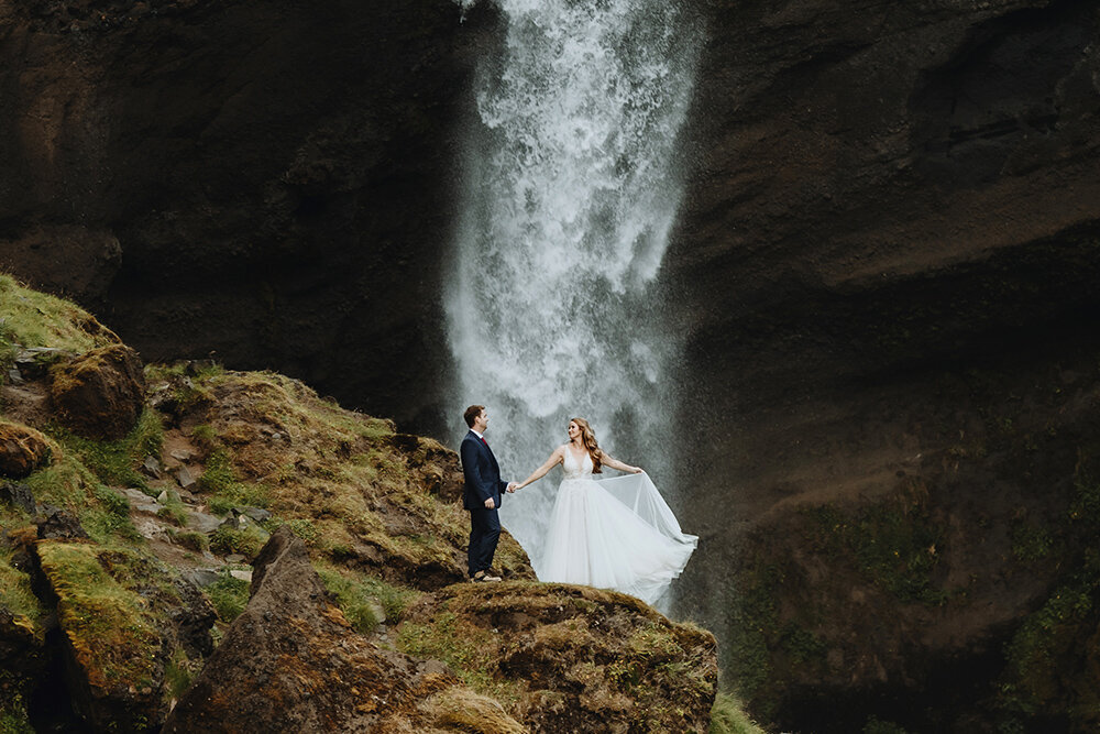 Bride and groom in front of a waterfall in Iceland