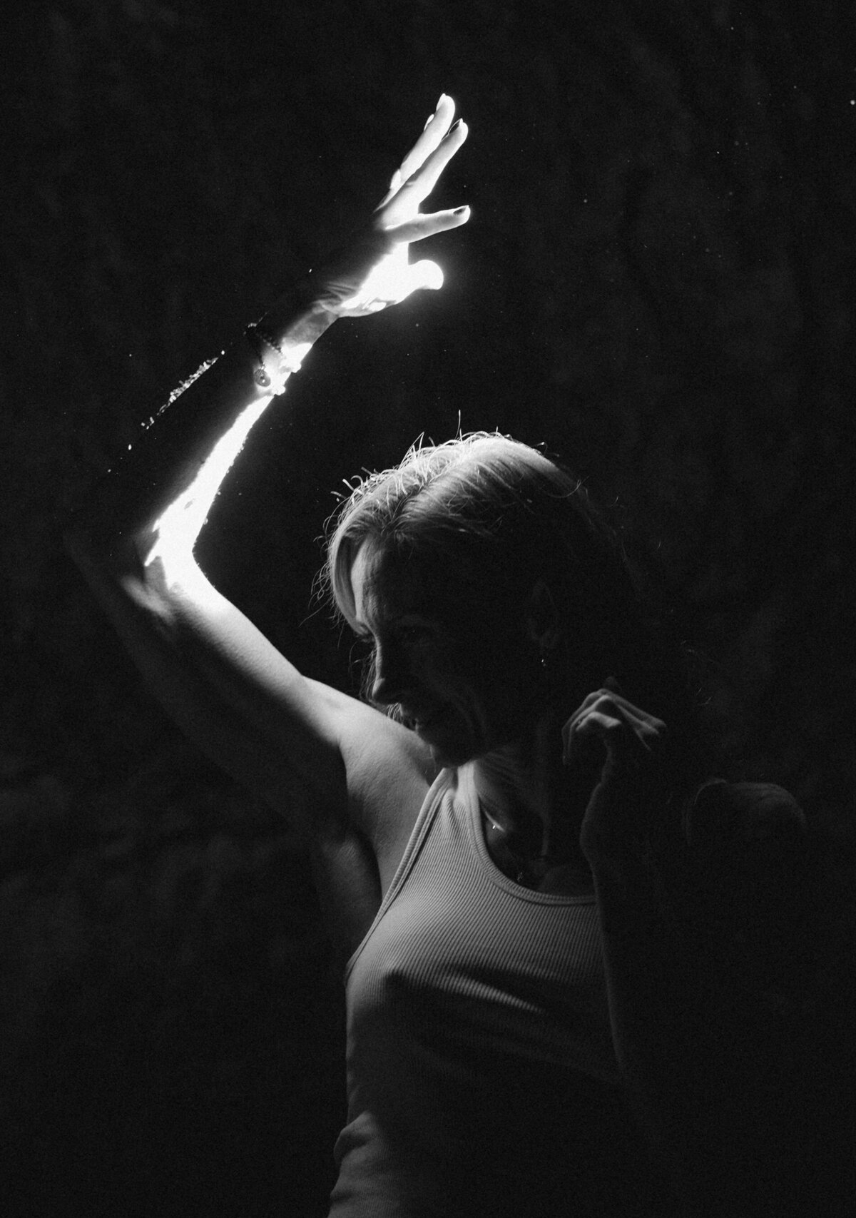 woman stands in cave as the light shines upon her in Bend, Oregon