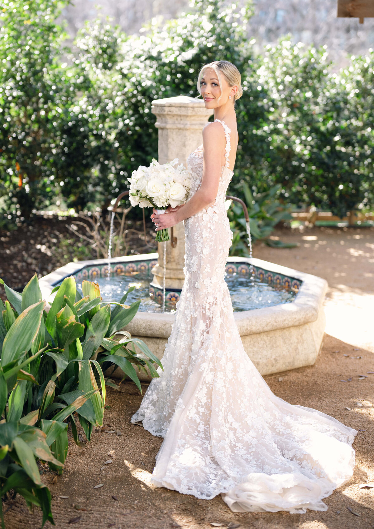 Bridal portraits at Hotel Drover, with the bride in a lace  Galia Lahav gown holding a white bouquet
