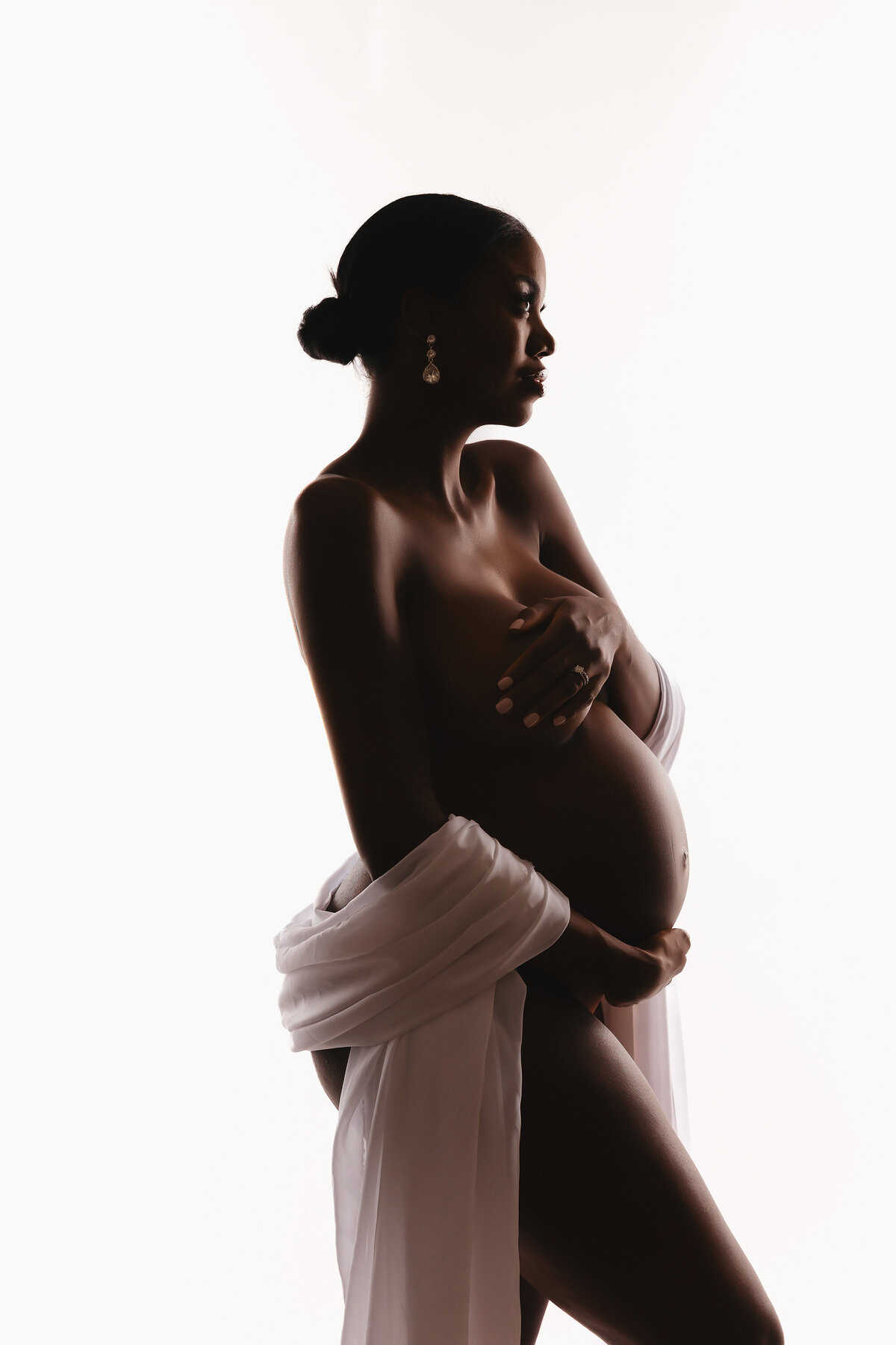 black pregnant woman posing for phoenix maternity photographer
