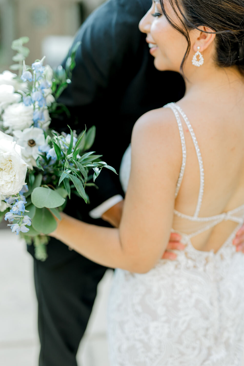 Bride holding her greenery and white bouquet