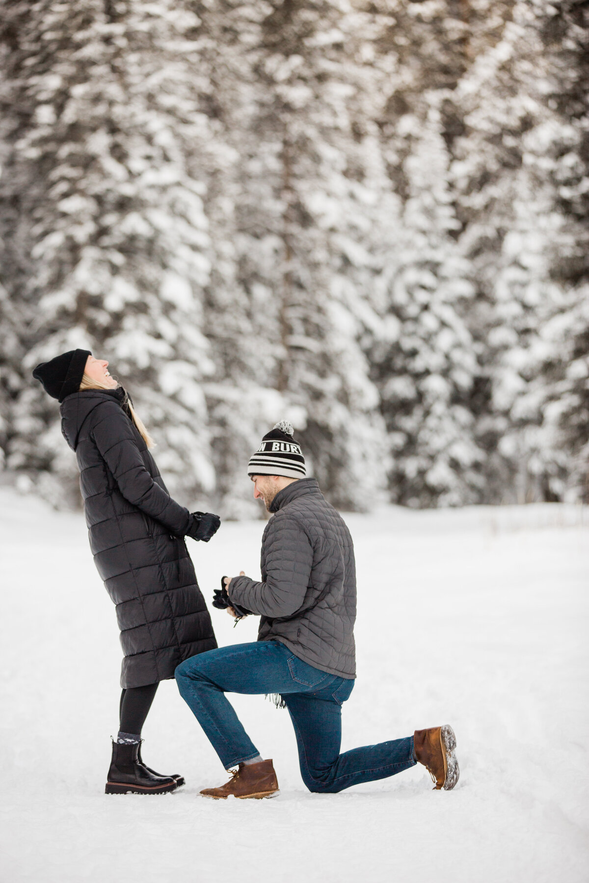 Rachel photographing couple who are getting engaged amidst a winter scene
