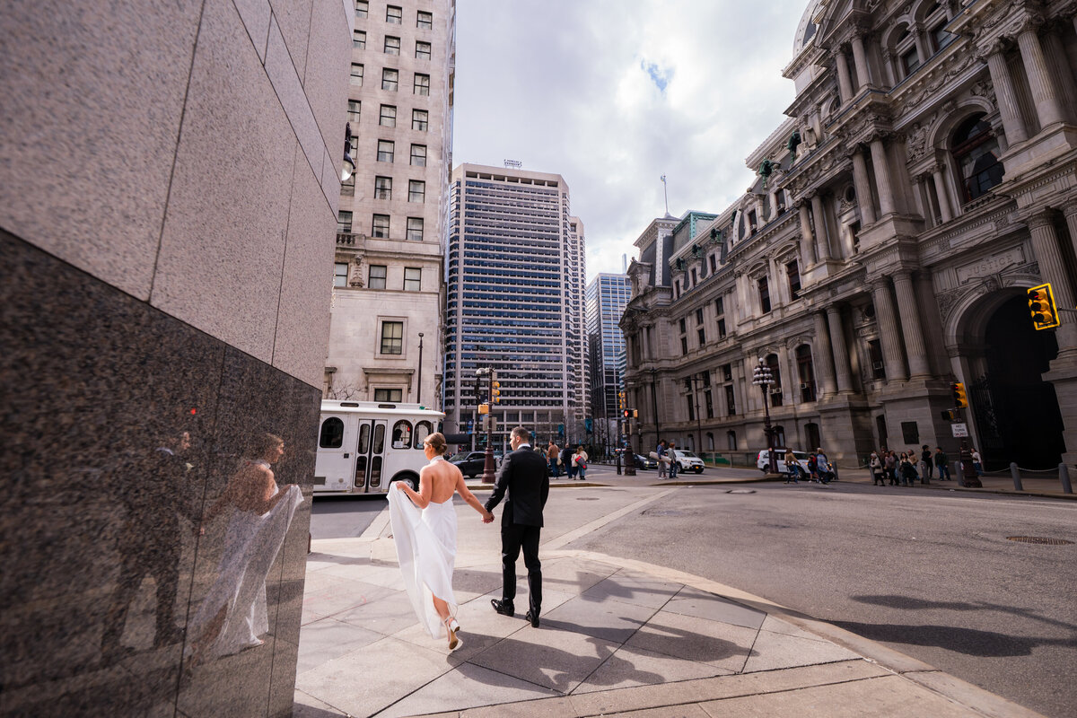 Bride and Groom walking the streets of philadelphia on their wedding day 