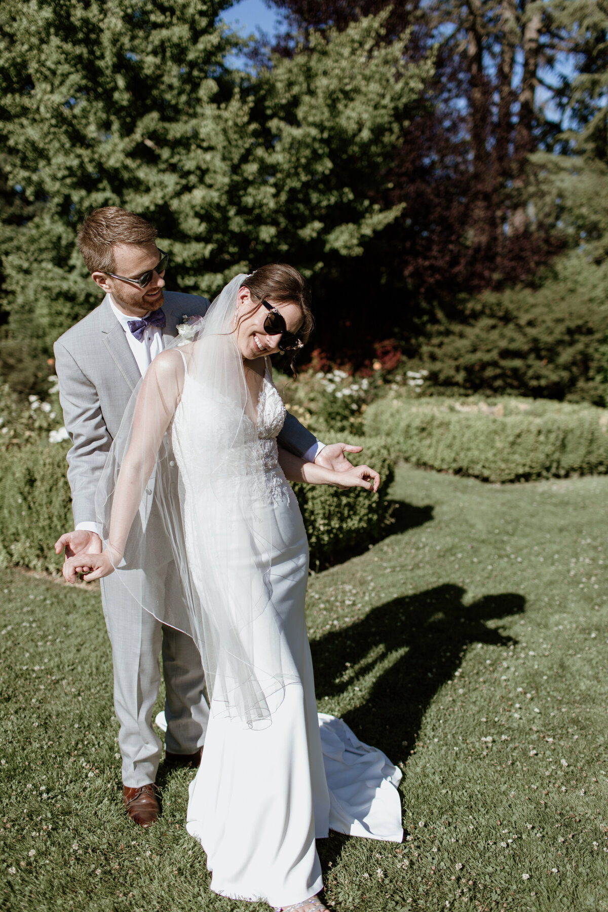 A fun candid moment between a bride and groom at the Woodland Park Zoo Rose Garden in Seattle. Captured by Fort Worth Wedding Photographer, Megan Christine Studio