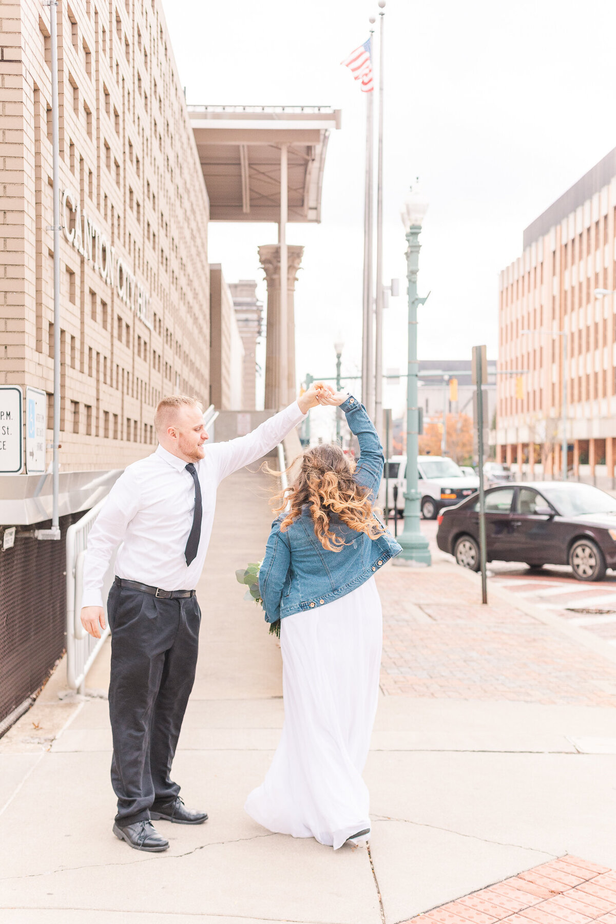 bride and groom twirl in the streets and celebrate their nuptials in downtown Canton , Ohio
