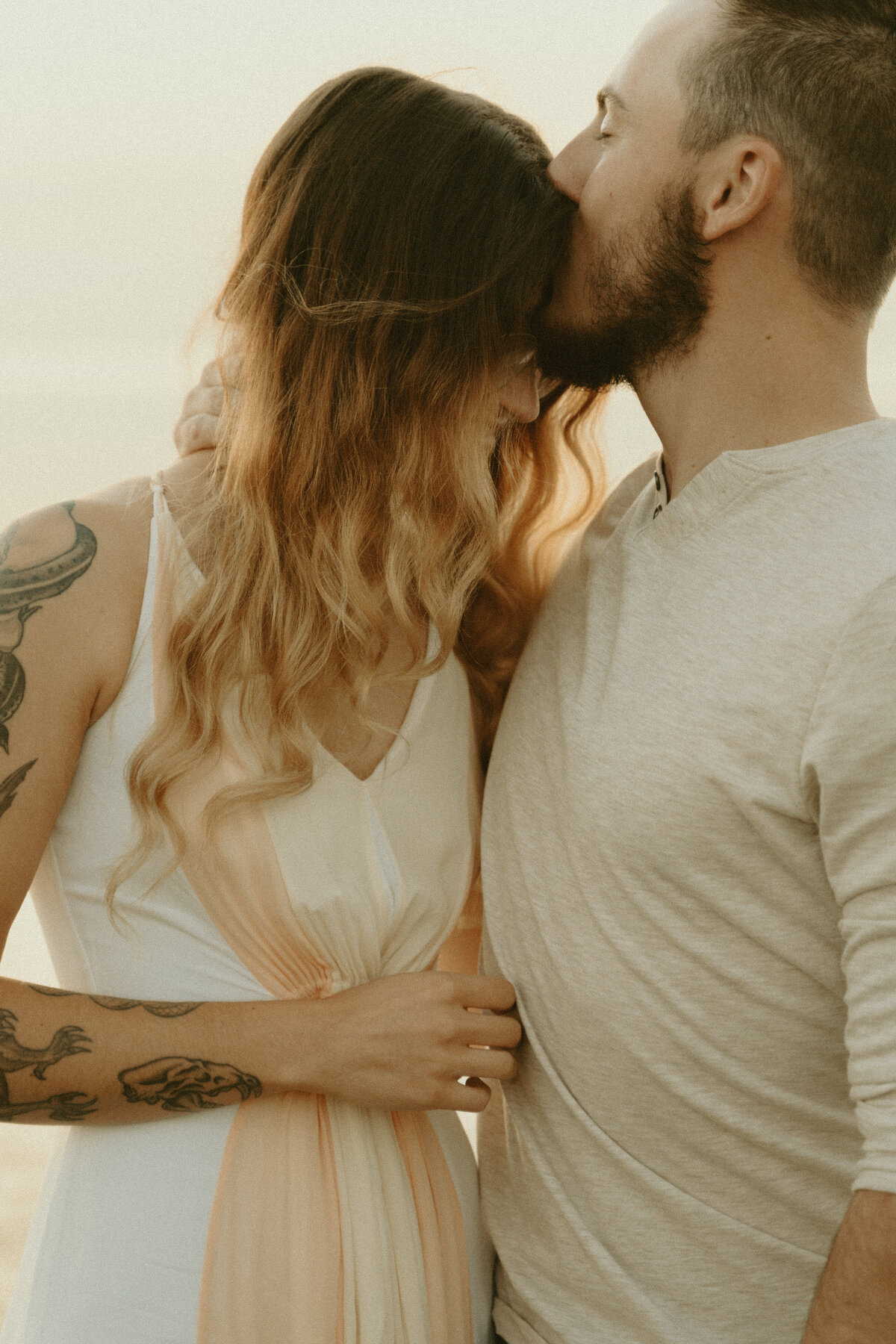 serene forehead kiss engagement photo at the beach