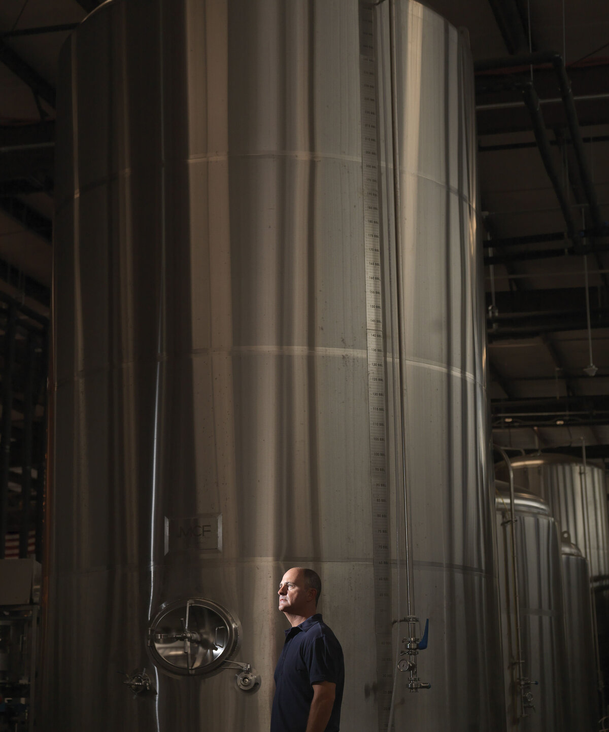 A person standing on a brewery floor