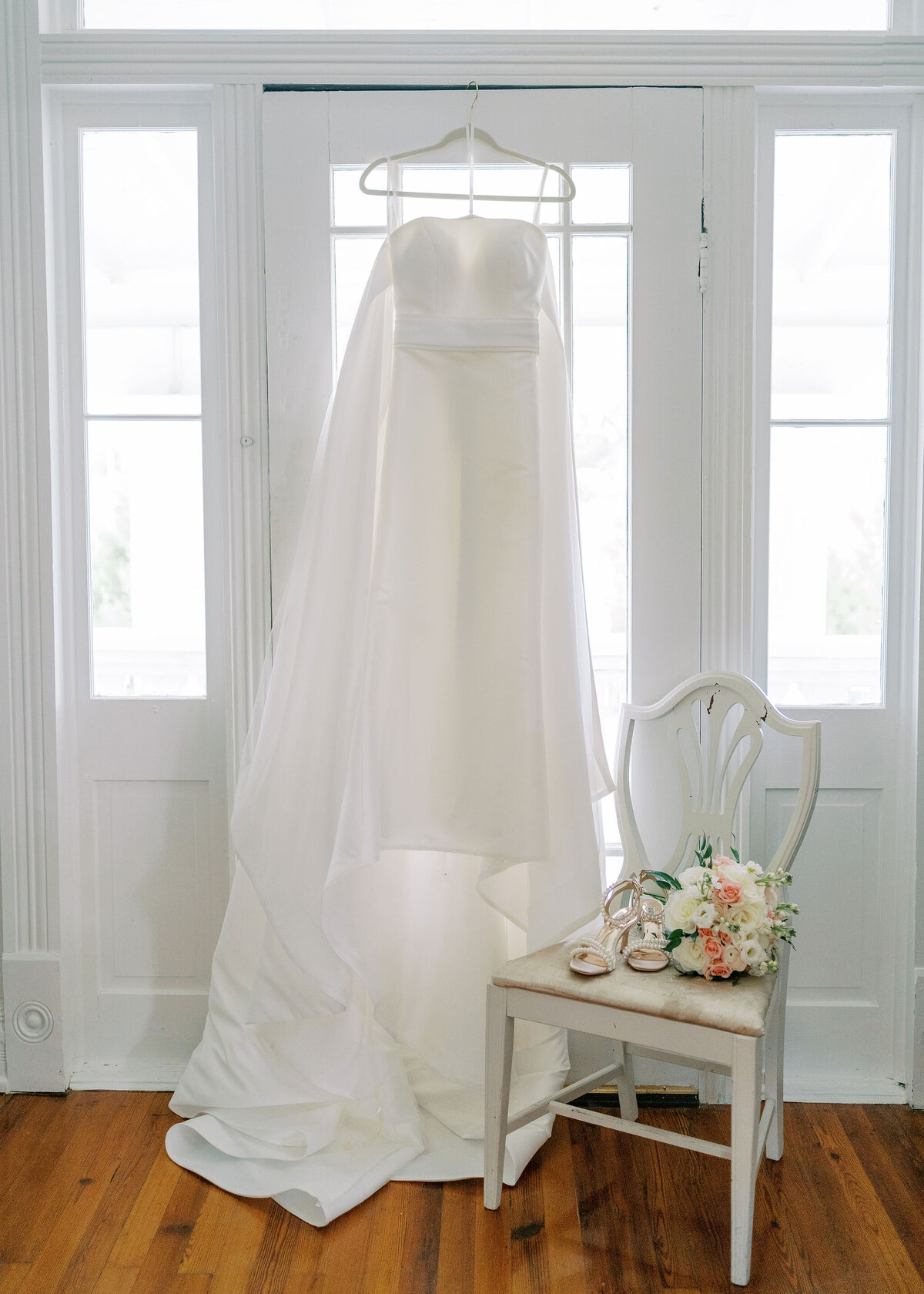 wedding dress hanging on a door