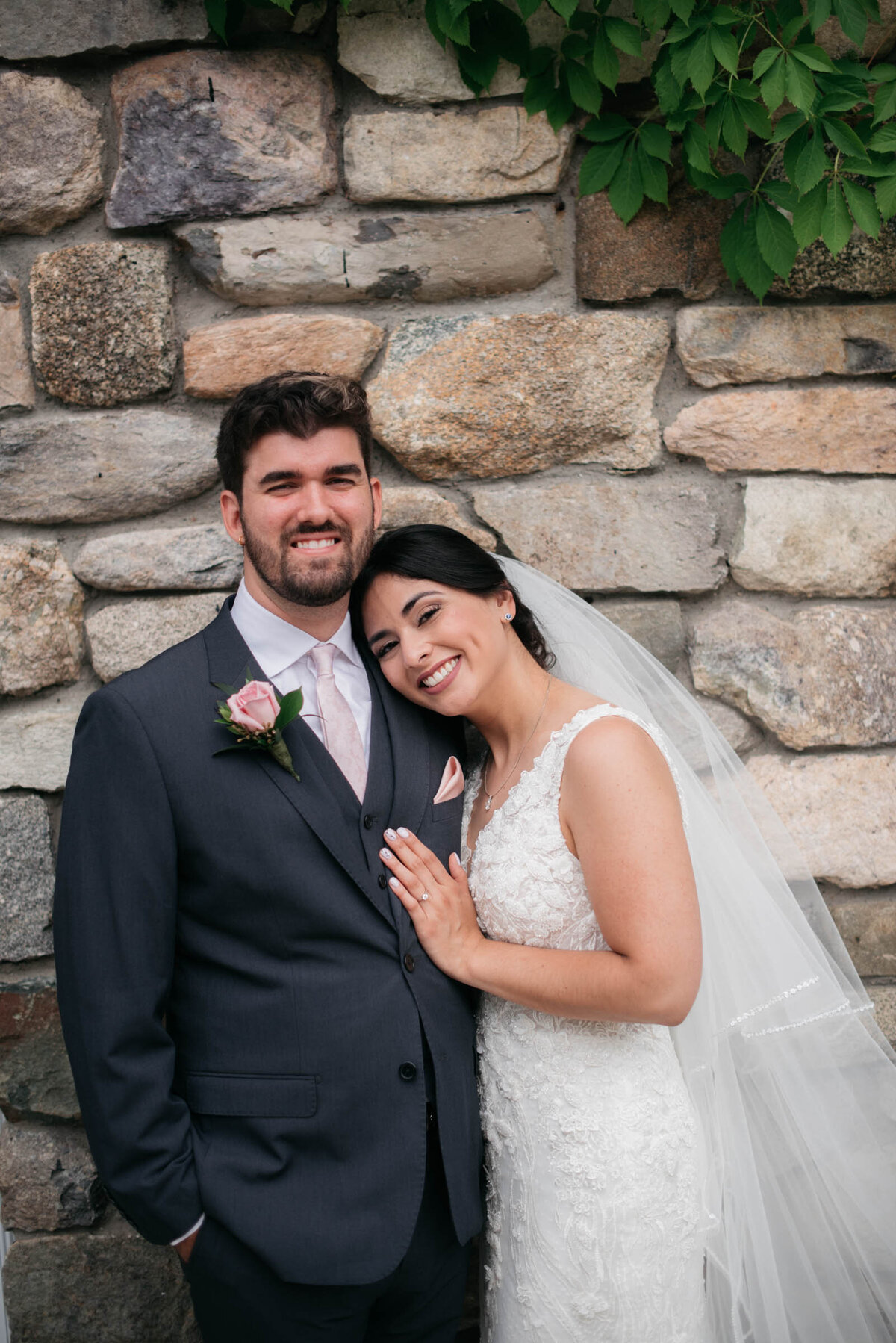 bride and groom portrait in front of the stone building at the connors center boston wedding