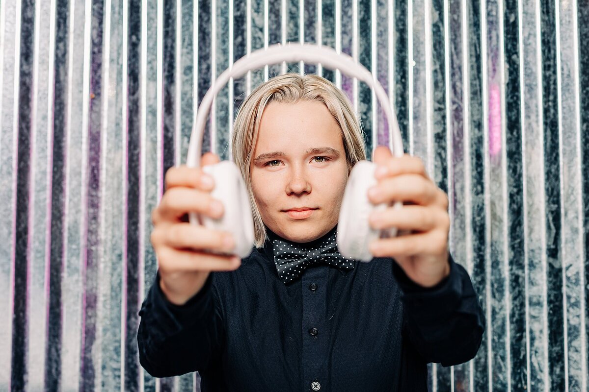 Female dj holding white headset for a branding photoshoot