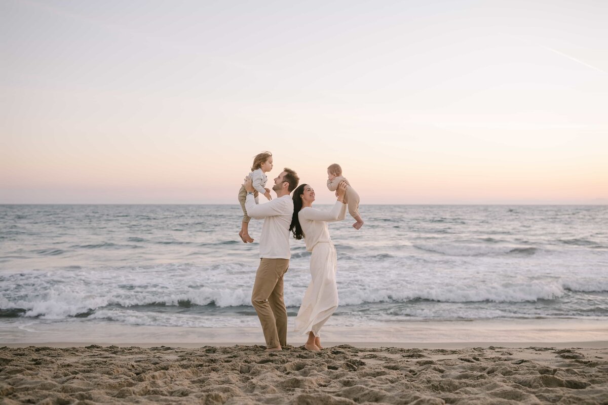 Orange County Family Photography - family during sunset holding their chidren up in the air -211