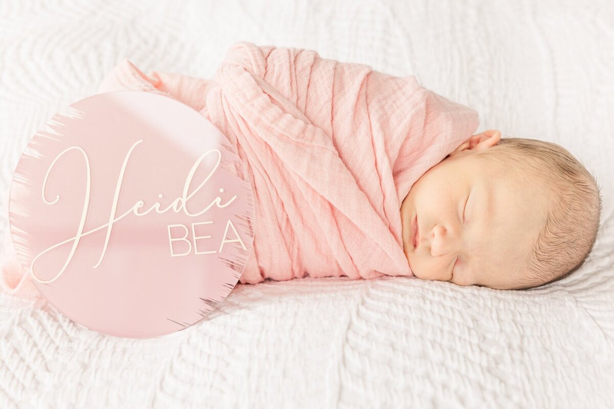 Baby girl with a name sign during a lifestyle newborn session