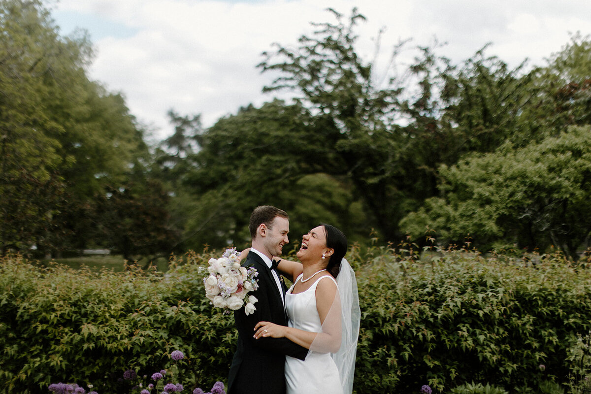 bride and groom laughing at each other