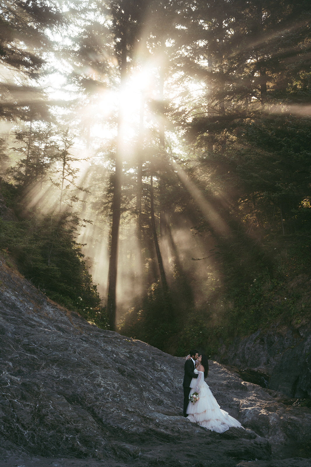 bride and groom standing on Oregon cliff sides