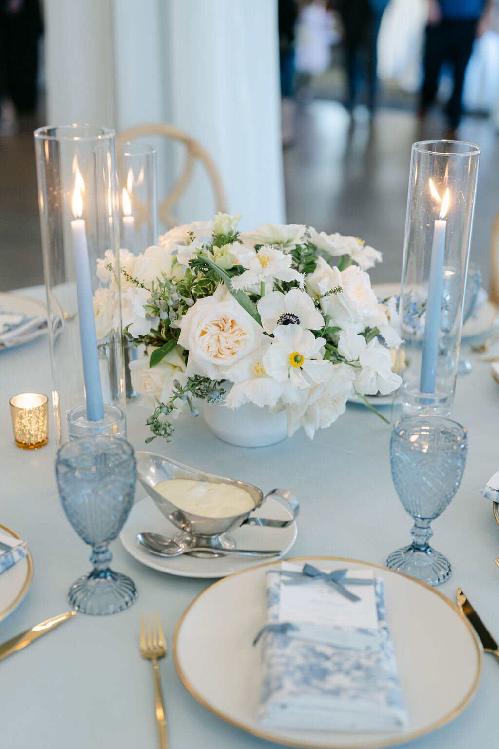taper candles, blue glassware, candle light, low centerpiece, anemones, white flowers
