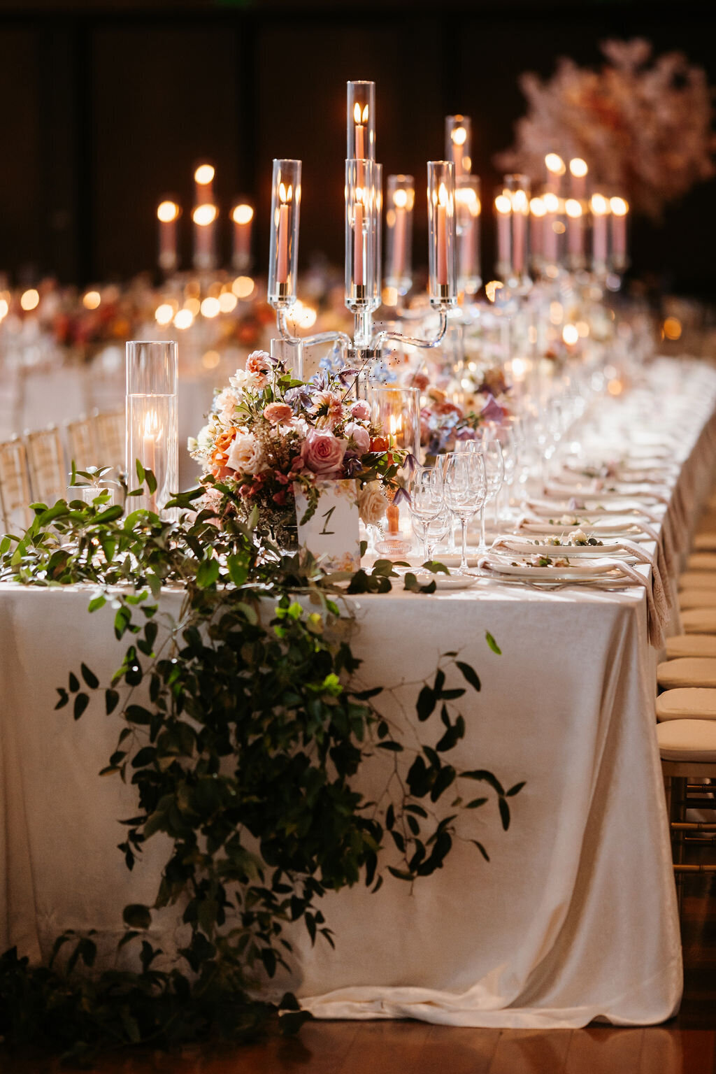 head table with pastel flowers and candelabras