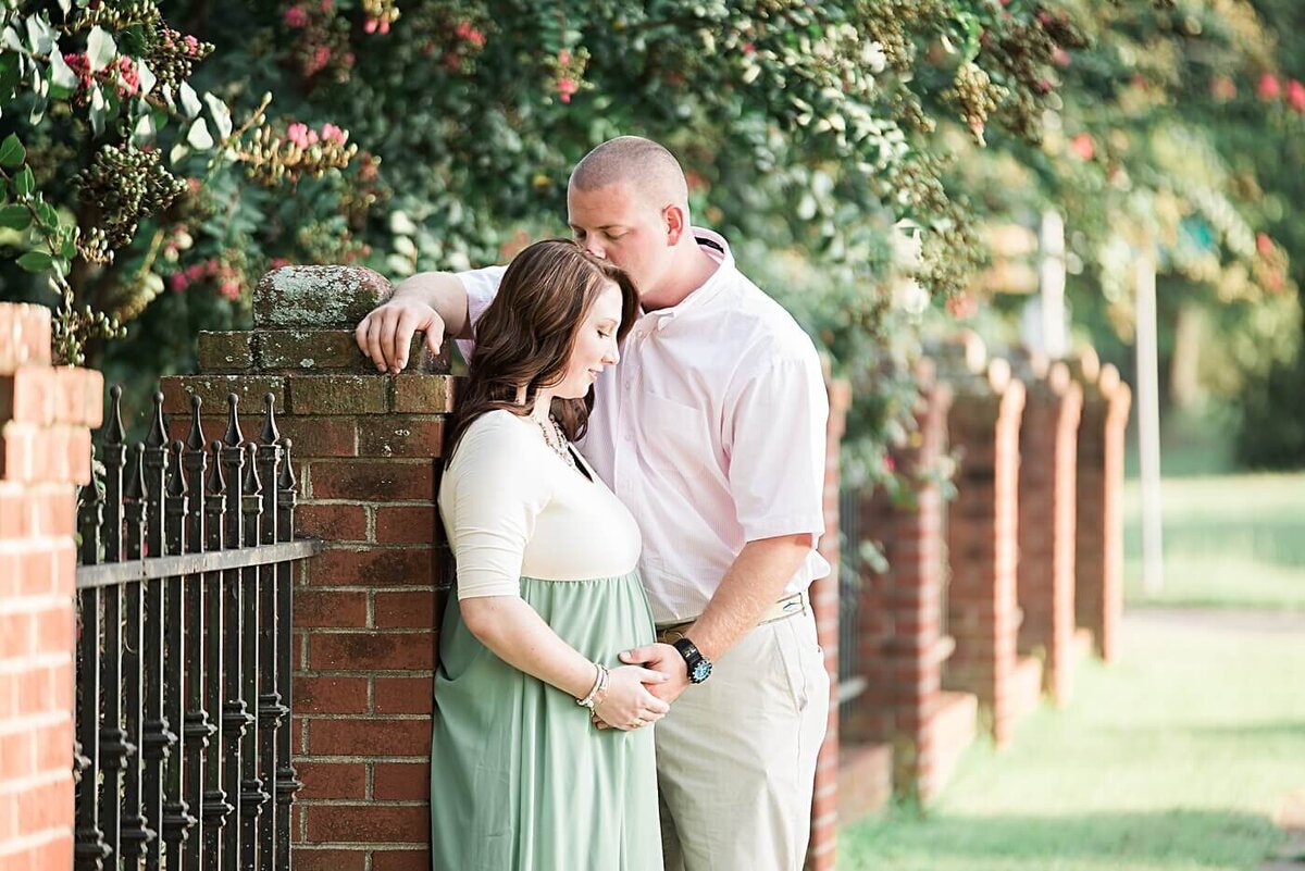 mom and dad looking at baby belly in hickory nc with their maternity photographer