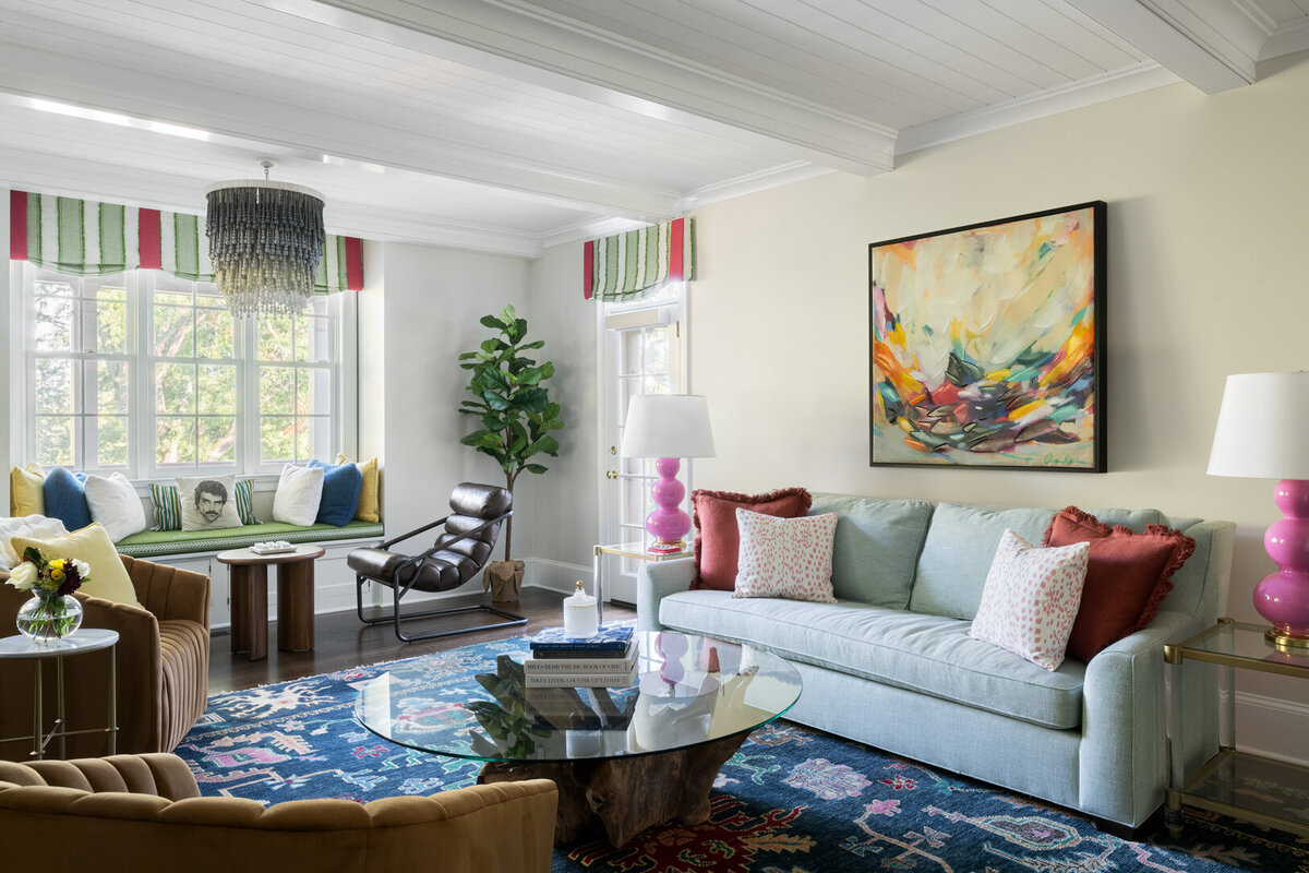 vibrant living room with colorful abstract painting and window seat 