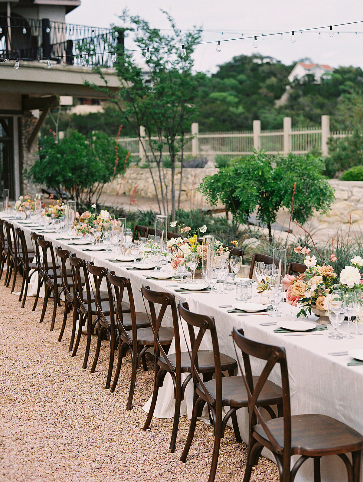 A long table is ready for guests to be seated in the Butterfly Gardens at Villa Antonia