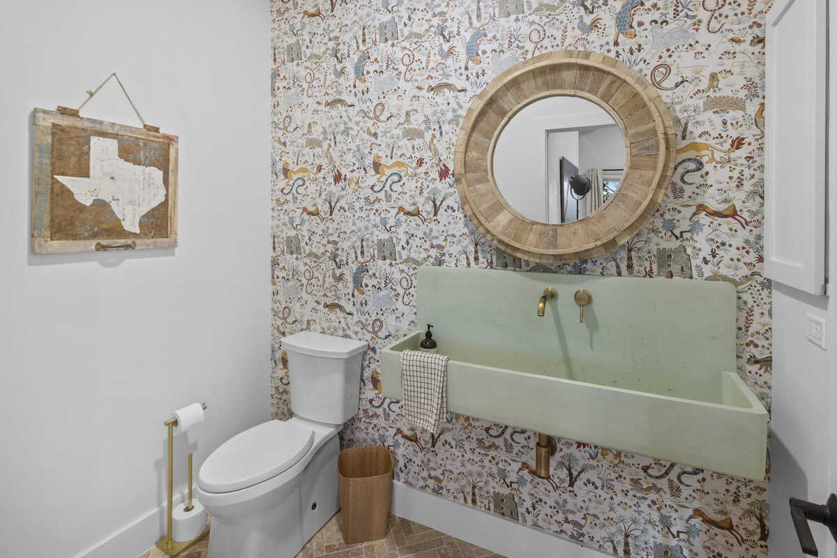 Bathroom with decorative wall and green washing basin