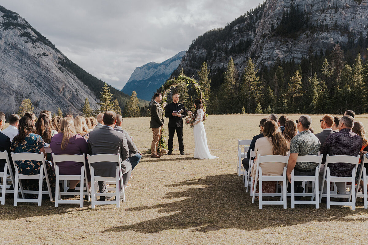 guests enjoy the intimate ceremony of a bride and groom in Banff National Park